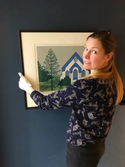 Laura Woodward, Wellington City Council Collections Registrar with artwork by Robin White titled Southland Monkey Puzzle, 1973, selected for the Capital Collection: The Eastern Bay Edition by Mayor Tony Bonne. 