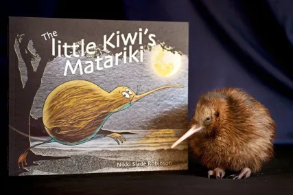 Picture of Nikki Slade Robinson's The little Kiwi's Matariki book and a real kiwi