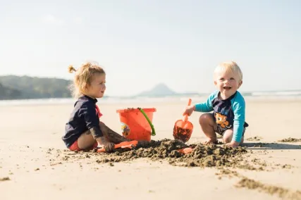 Two kids playing on Ōhope Beach.