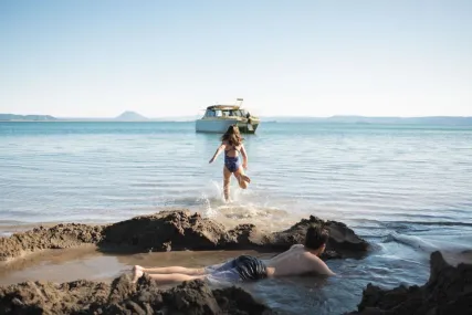 Kids playing on the beach at Moutohora Island