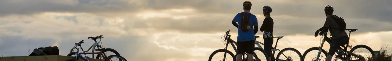 Cyclists watching the sunset on Motu Trails