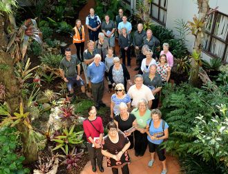 Members of the Eastern Bay of Plenty Bromeliad and Orchid Club join Council staff and representatives of Pride Whakatāne to celebrate the rejuvenation of the Civic Centre atrium garden.