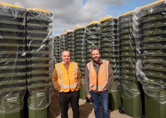 Whakatāne District Council Solid Waste Manager Nigel Clarke (left) and Kevin Sullivan, Whakatāne Branch Manager, Waste Management NZ Ltd, with some of the District’s 14,000 new recycling bins.